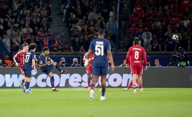 Desire Doue, third left, scores