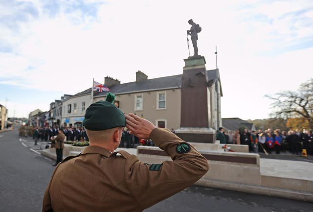 A soldier salutes during the Remembrance Sunday service at the cenotaph in Enniskillen