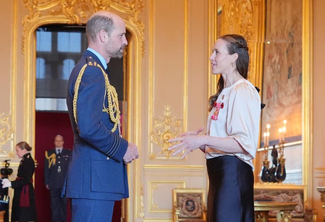 Helen Glover being made an OBE by the Prince of Wales