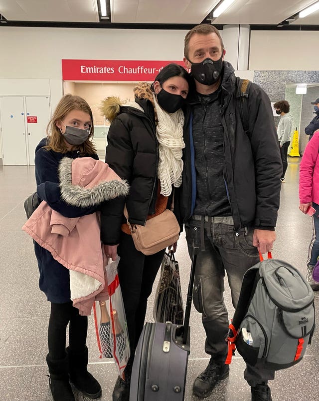 Paul Meakin, his wife Svetlana and their daughter arrive at Gatwick from Kyiv, Ukraine (Sophie Wingate/PA)
