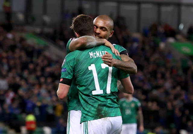 Josh Magennis, right, congratulates Paddy McNair after his corner led to Benas Satkus'' own goal