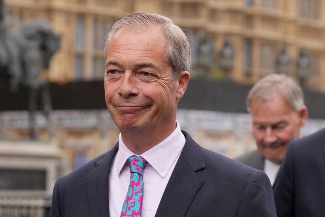 Reform UK leader Nigel Farage smiles as he arrives at the Commons