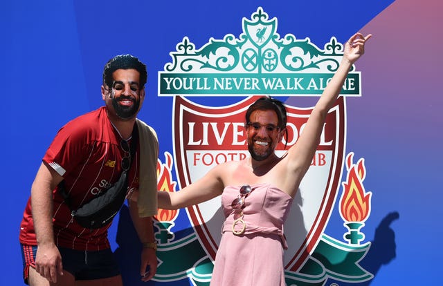 Liverpool fans wear Mohamed Salah and Jurgen Klopp masks in Madrid