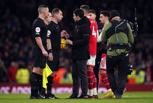 Mikel Arteta, centre, speaks to the referees after Arsenal's draw with Brentford