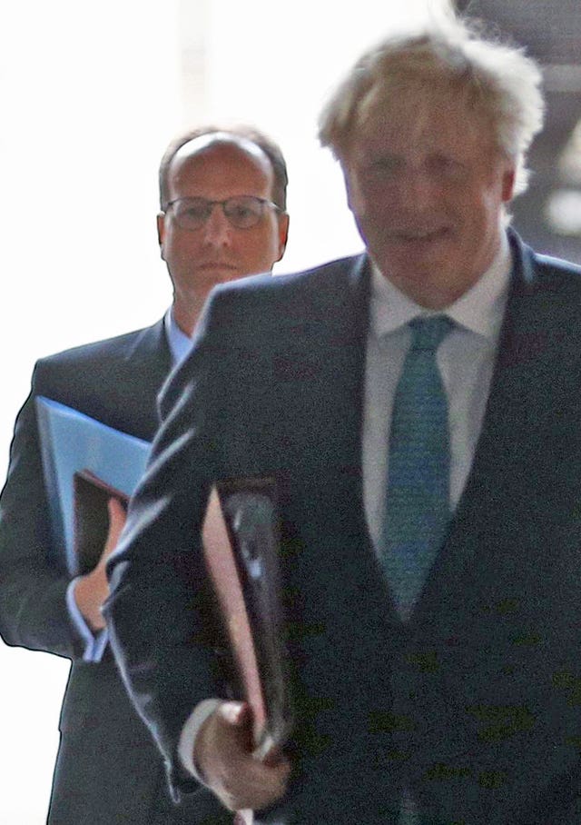 Boris Johnson followed by his principal private secretary, Martin Reynolds