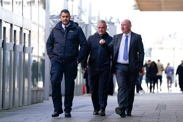 Pc Stephen Evans (centre) arriving at Empress State Buildings in London during his conduct hearing over allegations of assaulting minor