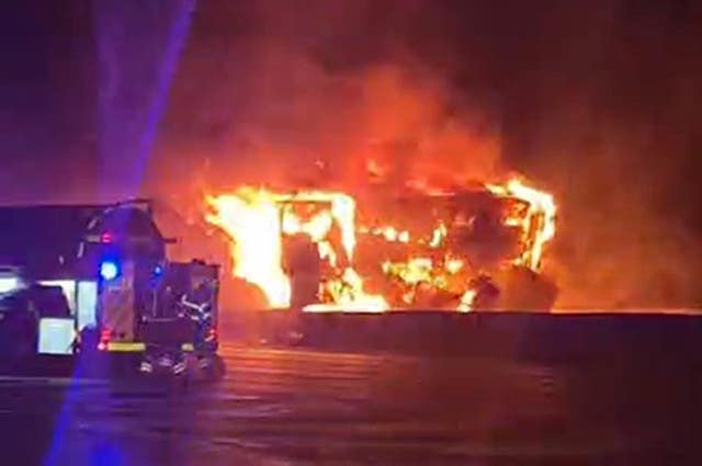 A screengrab from footage of the lorry on fire on the M25 showing bright orange flames