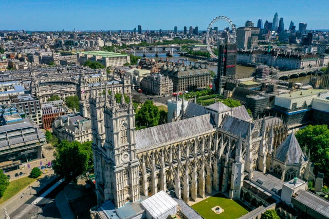 An aerial view of London showing Westminster Abbey (foreground), the London Eye, County Hall, Westminster Bridge, Hungerford Bridge, Waterloo Bridge and Parliament Street