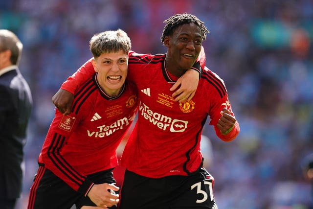 Manchester United’s Alejandro Garnacho (left) and Kobbie Mainoo celebrate after winning the Emirates FA Cup final at Wembley Stadium