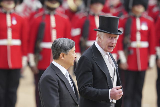 Charles chats to Emperor Naruhito after inspecting the Guard of Honour from members of the Welsh Guards