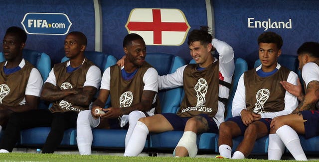 Sterling (centre left) was an unused substitute in the defeat to Belgium