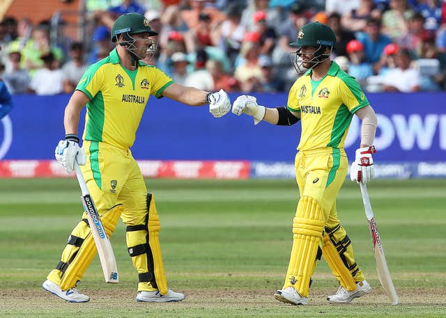 Warner (right) and Finch walk to the crease
