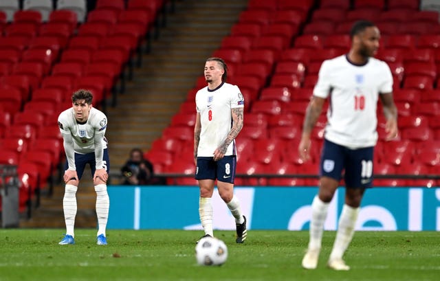 John Stones, left, reacts after his error led to a Poland equaliser