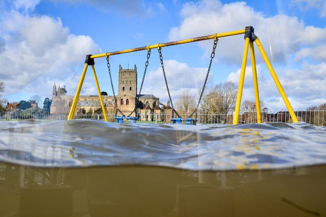 A playground sits partially submerged in floodwater in Tewkesbury