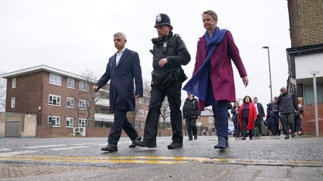 Mayor of London Sadiq Khan and shadow home secretary Yvette Cooper during a walkabout with a police officer during a visit to Earlsfield Police Station, south west London.