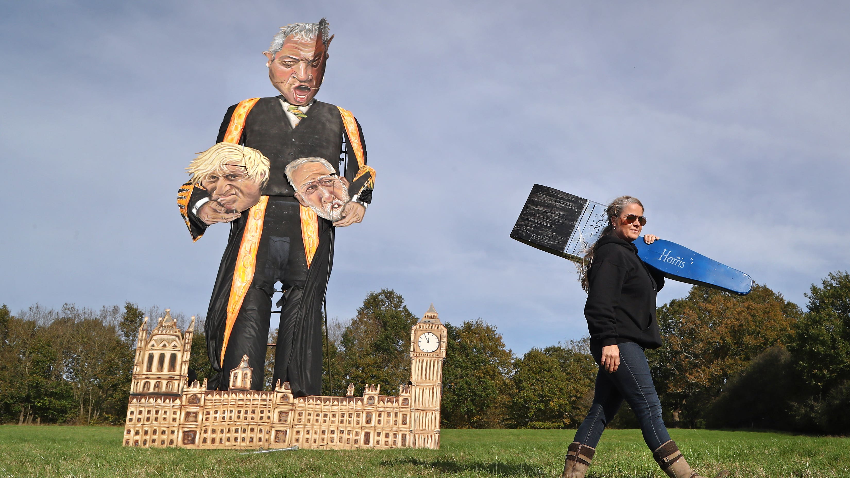 Artist Andrea Deans walks past the effigy of Speaker John Bercow