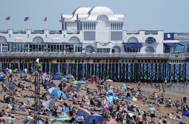 People enjoy the warm weather on Southsea beach in Hampshire 