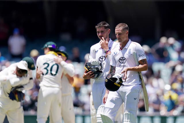 England's Josh Tongue (left) and Brydon Carse (right) walk off the field after defeat on day five of the third Ashes Test in Adelaide