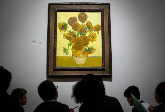 School children look at Sunflowers by Vincent Van Gogh