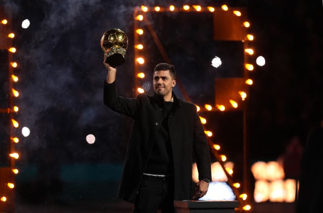 Manchester City’s Rodri poses with the Ballon d’Or trophy