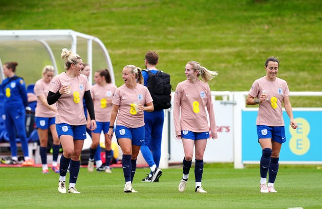 Millie Bright talks to England team-mate Beth Mead as they make their way out onto the training pitch