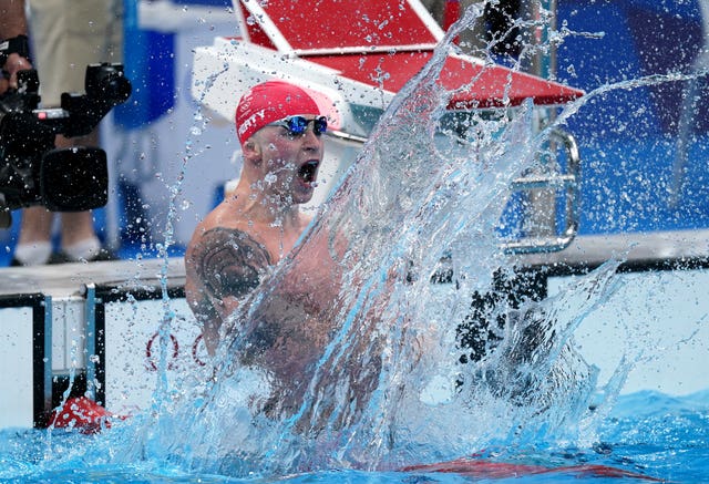 Adam Peaty celebrates retaining his men's 100 metres breaststroke title (Adam Davy/PA)