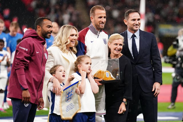 Chair of fhe FA Debbie Hewitt (second right) and former England players Frank Lampard (right) and Ashley Cole (left) present Harry Kane (centre) with a golden cap to mark 100 caps with his wife Kate Goodland and daughters Ivy and Vivienne ahead of the Nations League Group B2 match at Wembley