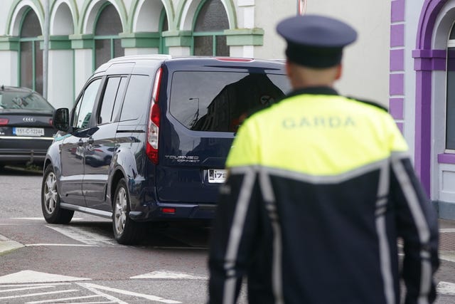 A vehicle and police officer on a street in Youghal