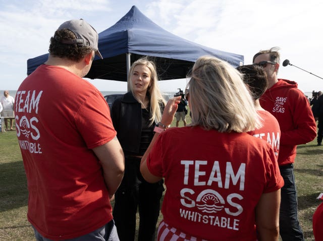 Singer Becky Hill speaks to campaigners at the protest