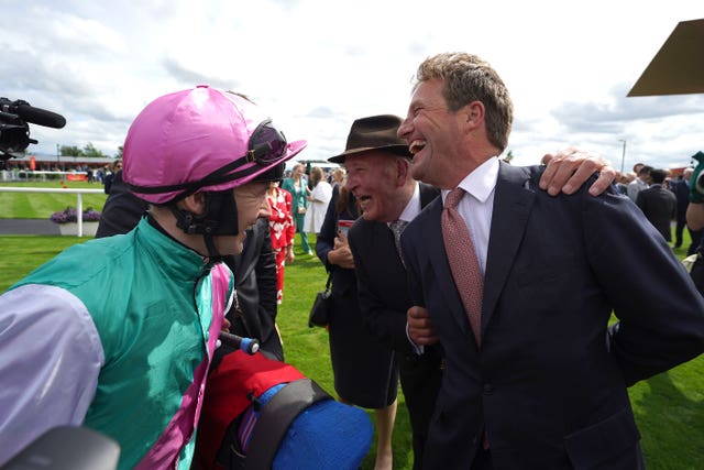 Jockey Colin Keane (left) and trainer Ralph Beckett (right) celebrate after winning the Dubai Duty Free Irish Derby with Westover at the Curragh 