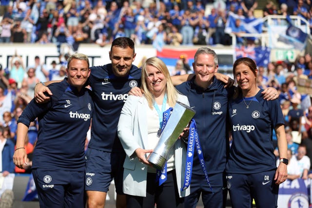 Emma Hayes, centre, and her backroom staff with the Women’s Super League trophy