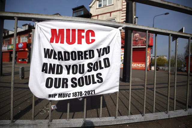 A banner left by Manchester United fans shows their anger