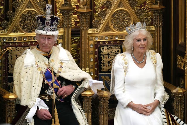 The King and Queen in their crowns and robes sat on their thrones at the State Opening of Parliament 