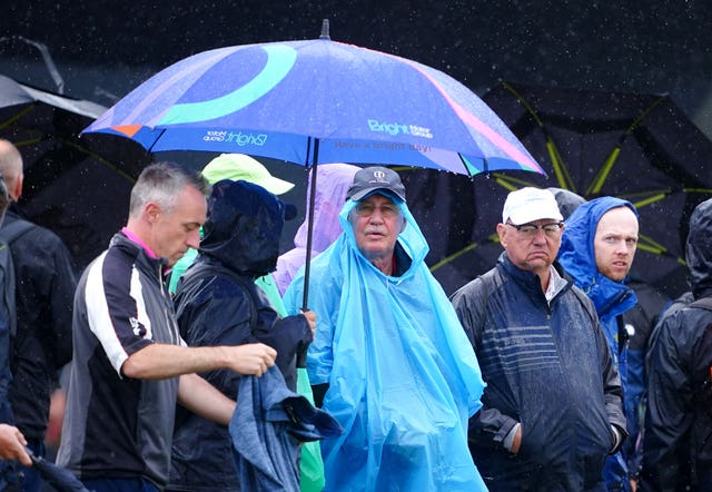 Golf spectators watch the action in the rain during day three of The Open at Royal Liverpool, Wirral 
