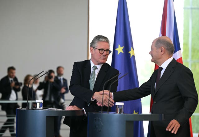 Prime Minister Sir Keir Starmer (left) and German Chancellor Olaf Scholz shaking hands at the end of a joint press conference