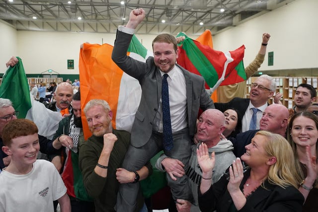 Donnchadh O Laoghaire being held up by supporters