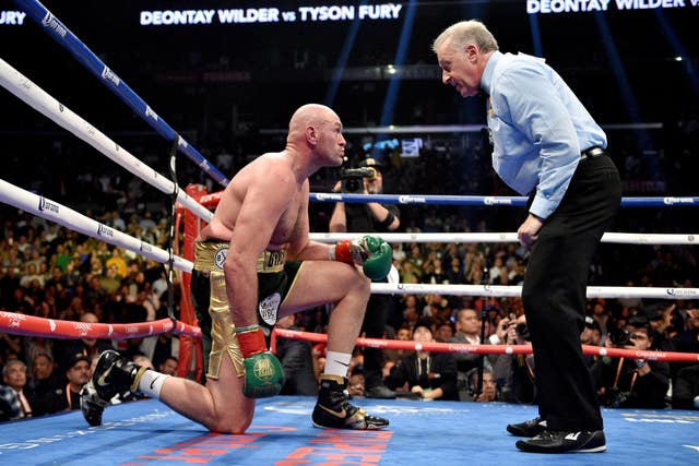 Tyson Fury, left, twice rose from the canvas against Deontay Wilder to battle to a draw (Lionel Hahn/PA)