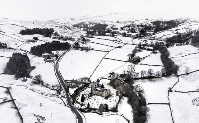 Snow covers fields and hills