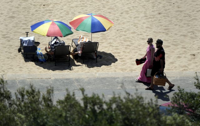 People under umbrellas on a beach