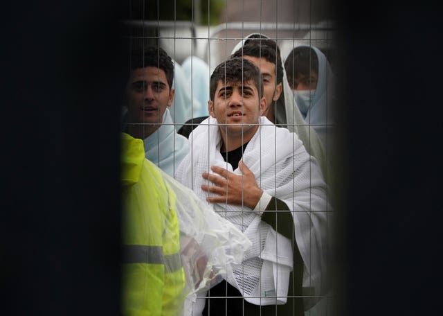 A view of people thought to be migrants inside the Manston immigration short-term holding facility located at the former Defence Fire Training and Development Centre in Thanet, Kent