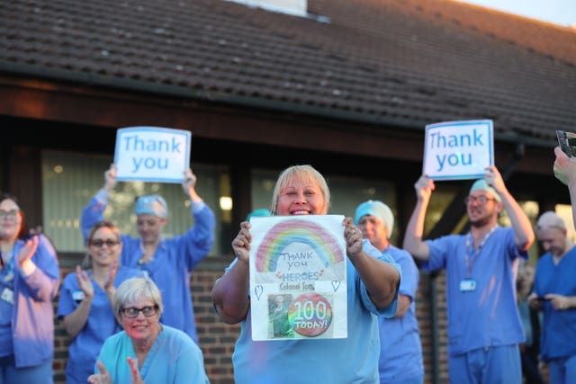 Medical staff outside the William Harvey Hospital in Ashford, Kent, join in the applause to salute local heroes during Thursday’s nationwide clap for carers