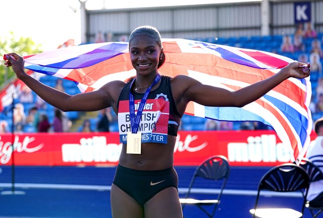 Dina Asher-Smith celebrates after winning the women's 100m final at the Muller British Athletics Championships