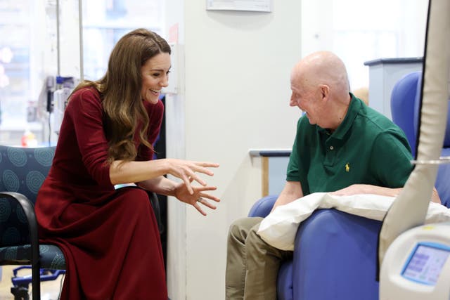 Kate talks with a patient in the treatment room 