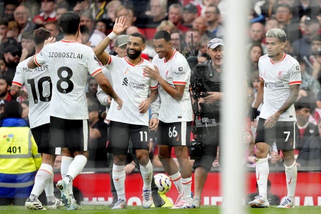 Liverpool players celebrate scoring a goal against Manchester United