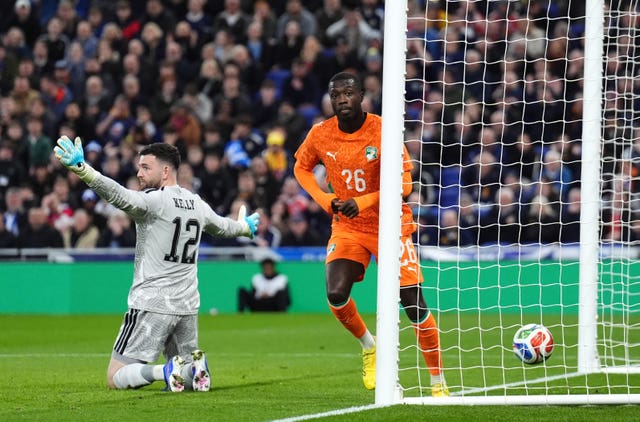 Scotland goalkeeper Liam Kelly gestures in frustration as Nicolas Pepe, right, turns away to celebrate after scoring the Ivory Coast&rsquo;s winner