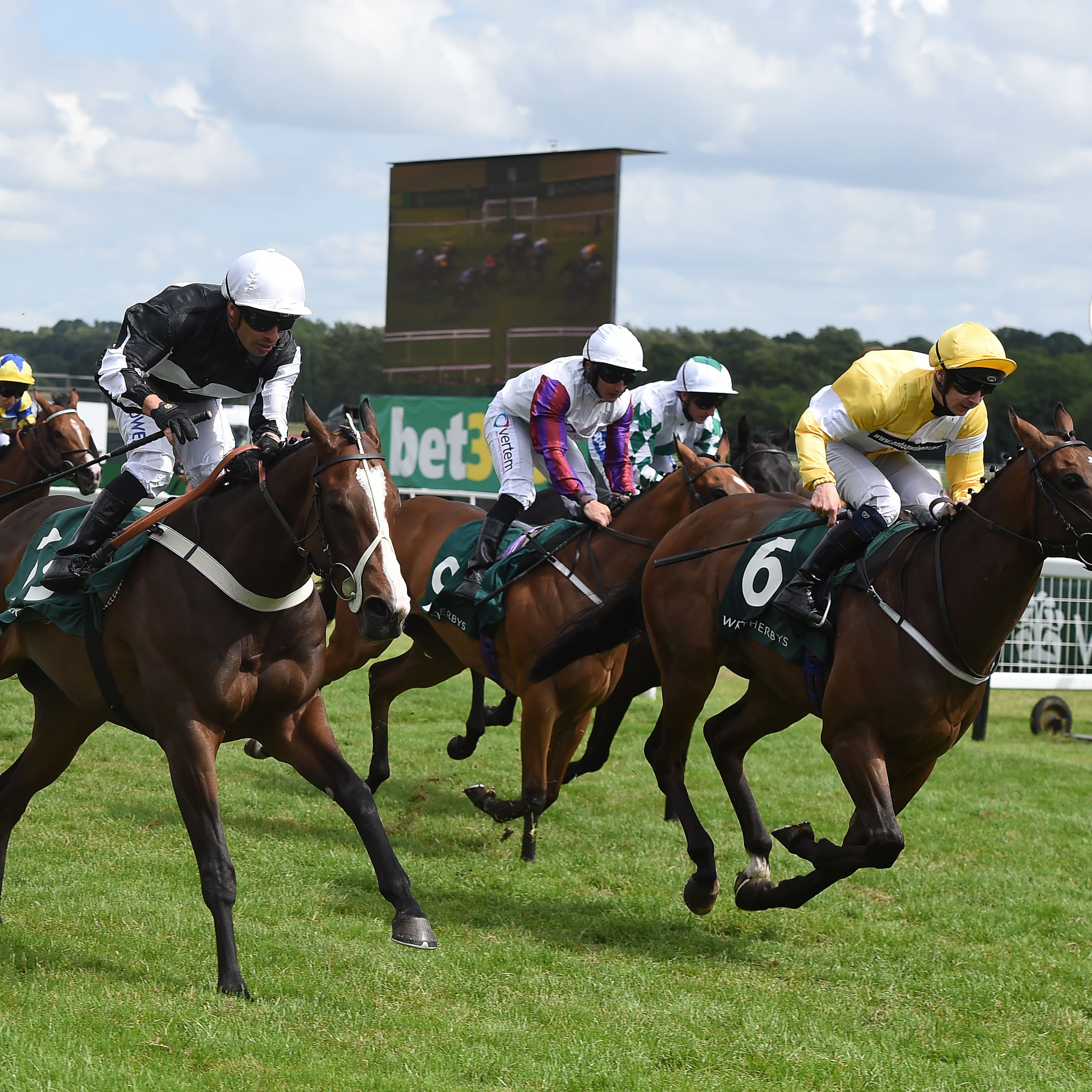 Silvestre de Sousa (near side) gets up close home to claim the Weatherbys Super Sprint at Newbury