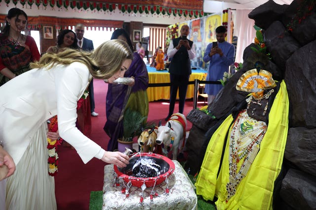Kate pouring a small amount of milk on the model of a mountain