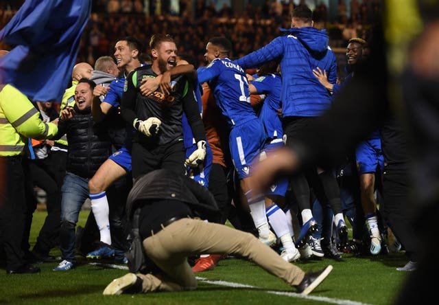 Colchester fans invade the pitch after their victory