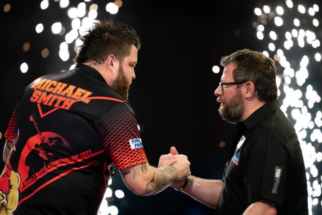 Michael Smith (left) held off a fightback from James Wade
