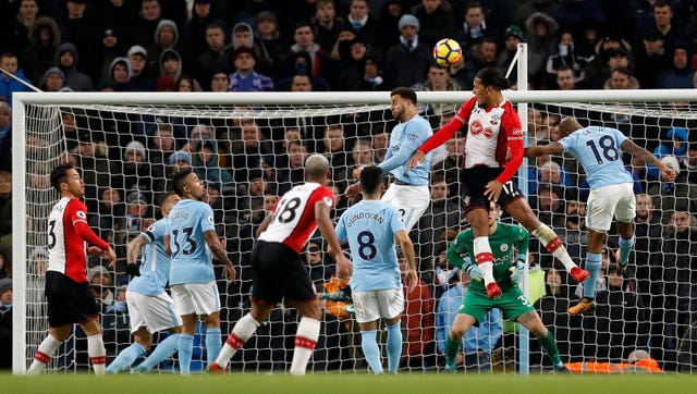 Virgil van Dijk heads at goal against Manchester City